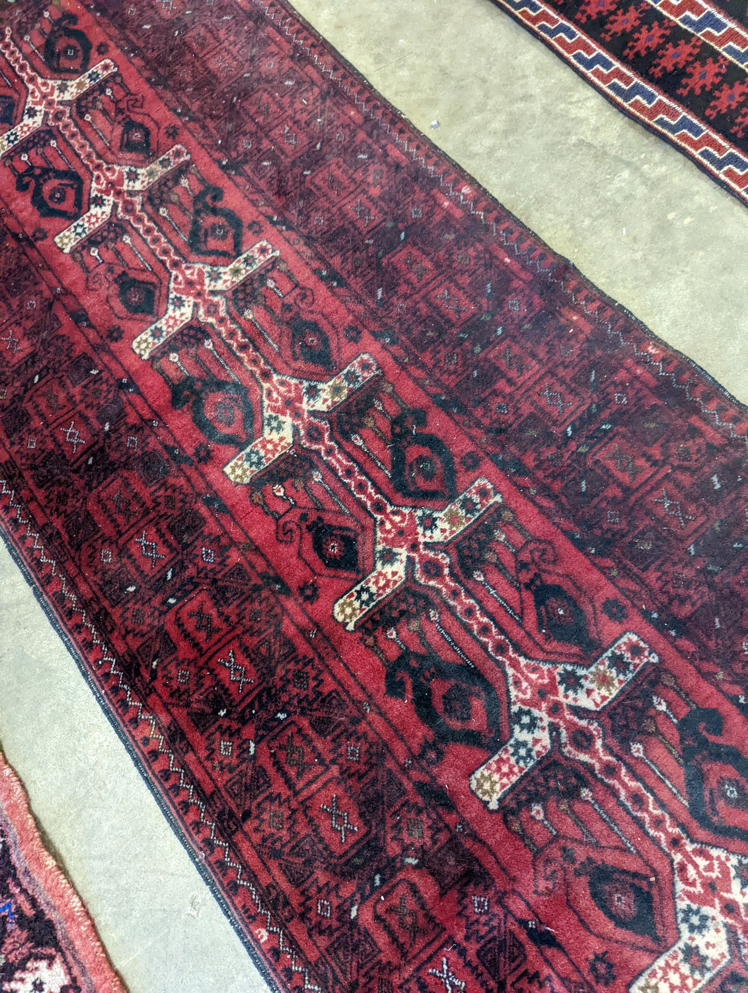 A Belouch red ground runner, 274 x 77cm